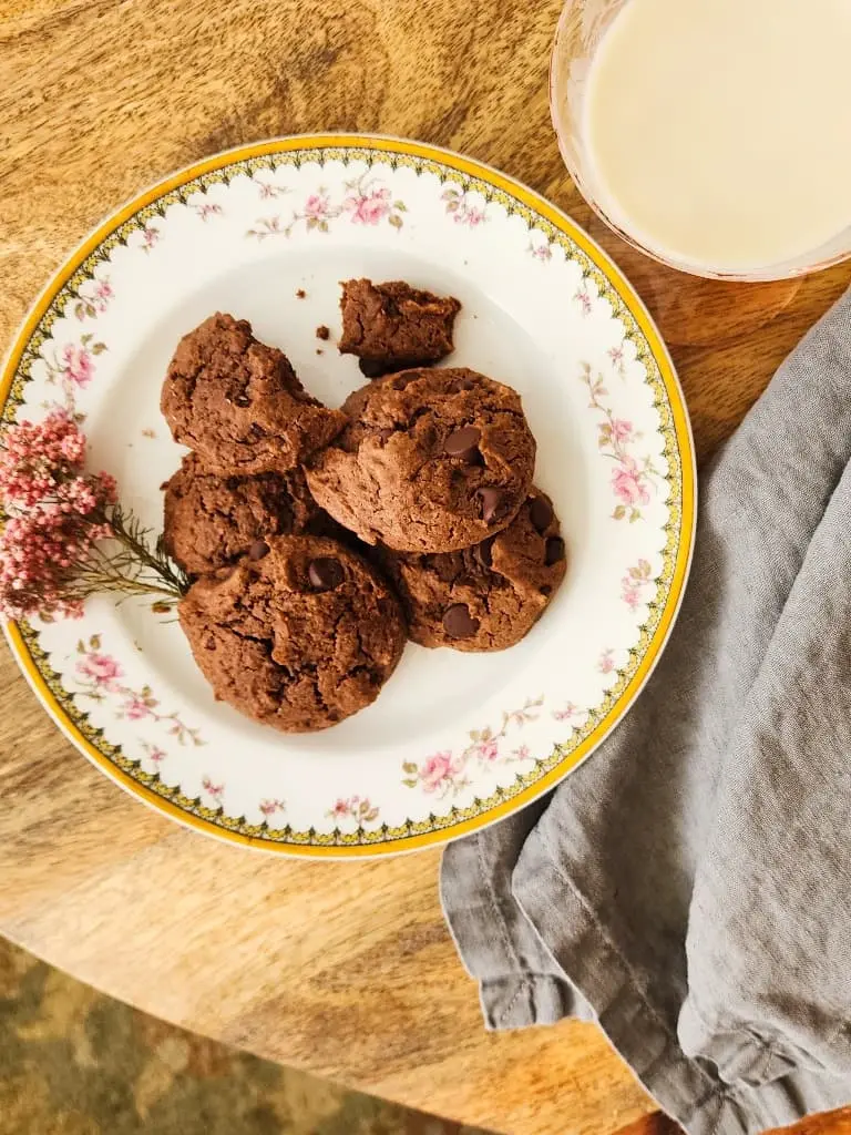 a plate of chocolate chip peanut butter cookies on a china plate