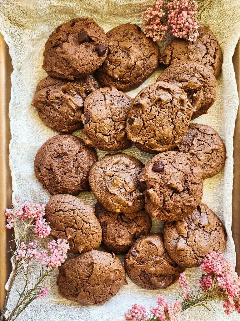 a cookie sheet of dark chocolate chocolate chip peanut butter cookies
