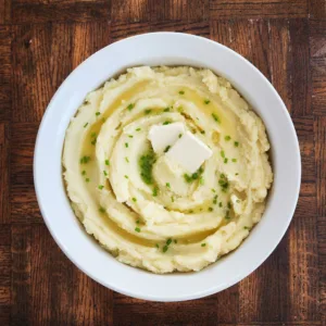 bowl of dairy free mashed potatoes with dairy free butter and chives on top