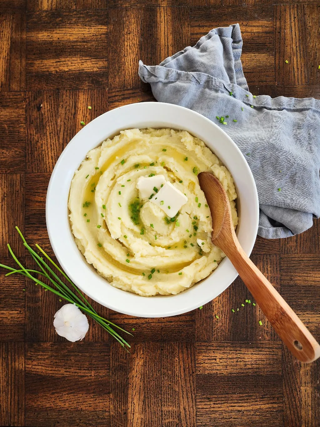 bowl of dairy free mashed potatoes with dairy free butter and chives on top