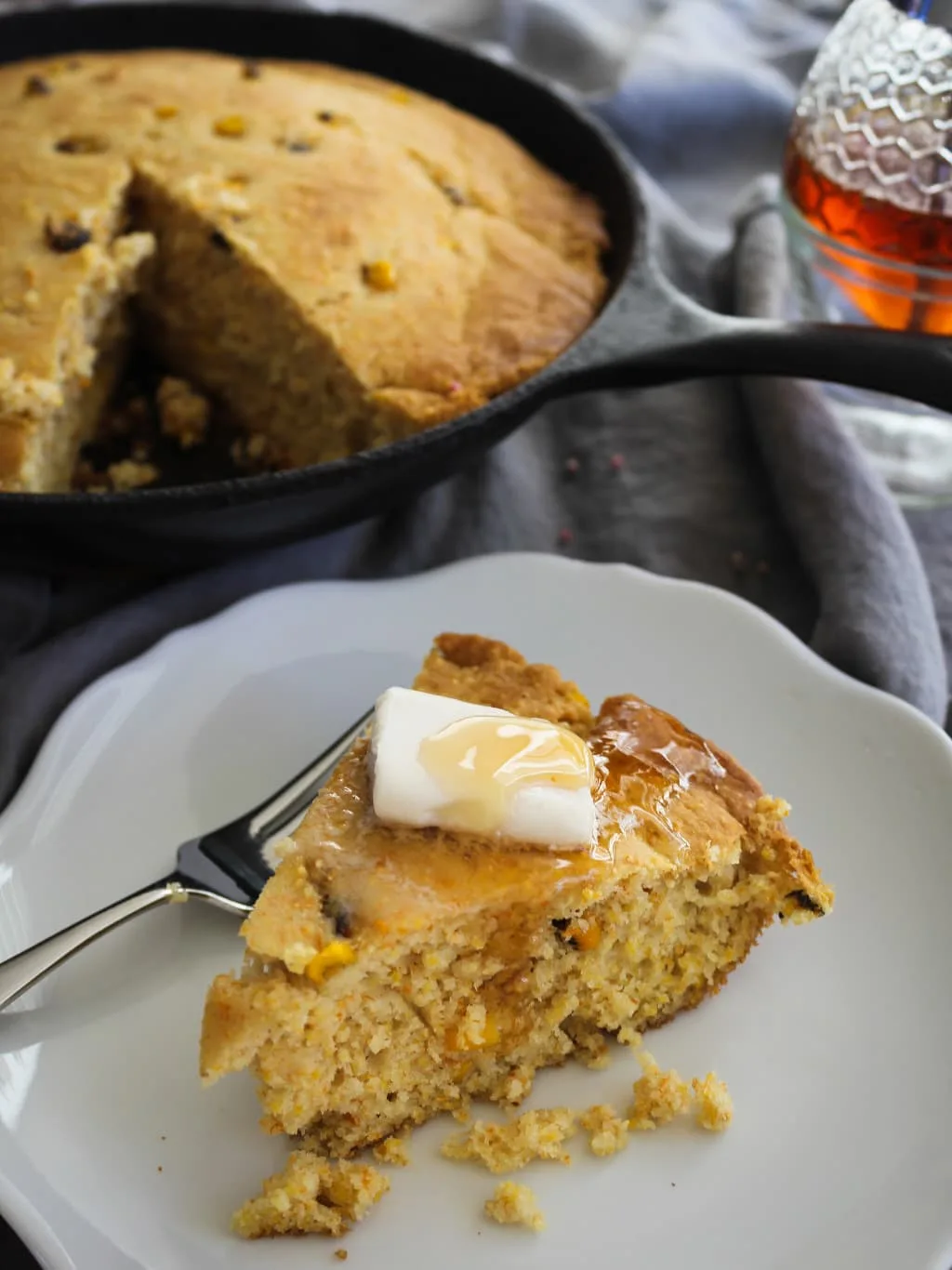 A serving of gluten free cornbread on a plate with dairy free butter