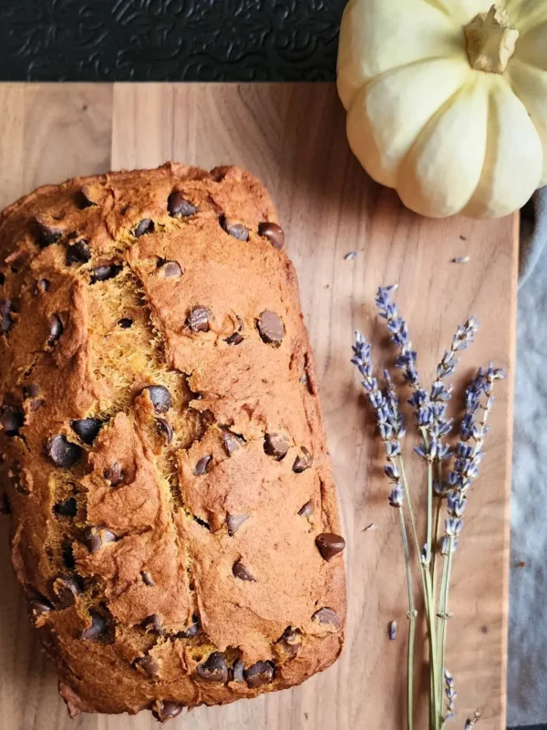 sliced gluten free pumpkin bread with chocolate chips on a wooden cutting board
