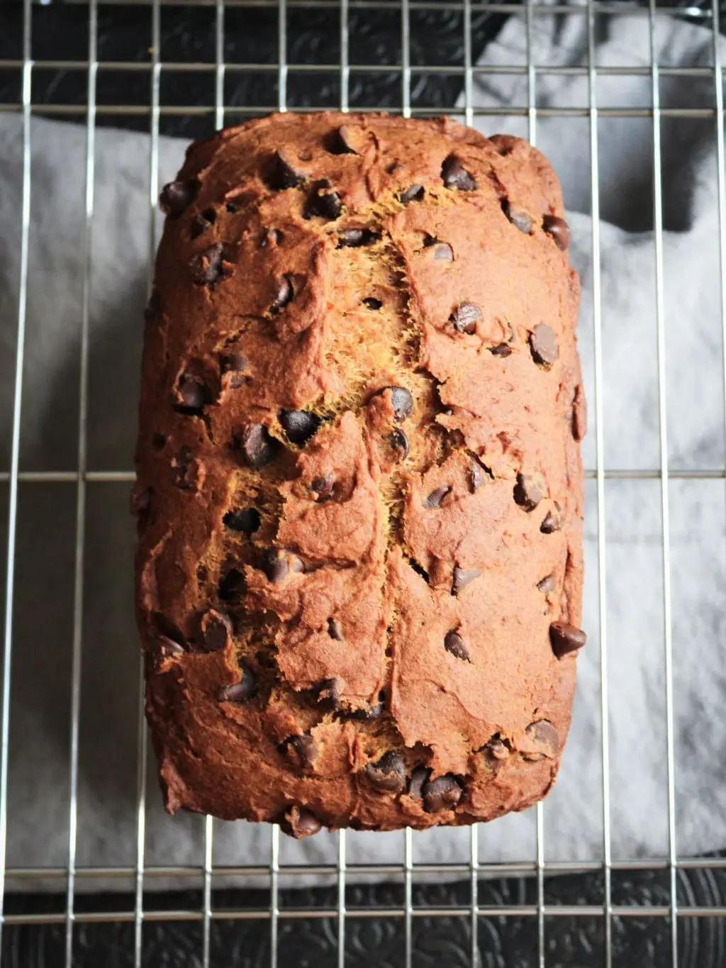 gluten free pumpkin bread with chocolate chips cooling on a wire rack