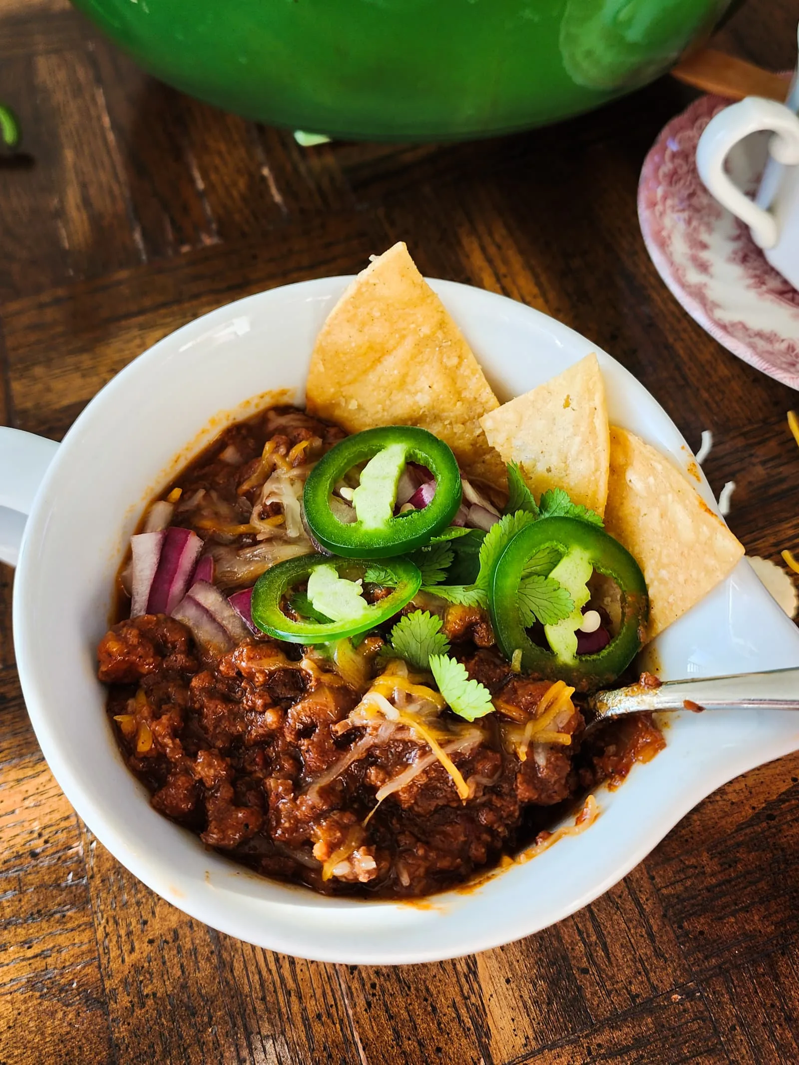 bowl of Texas-style chili with toppings