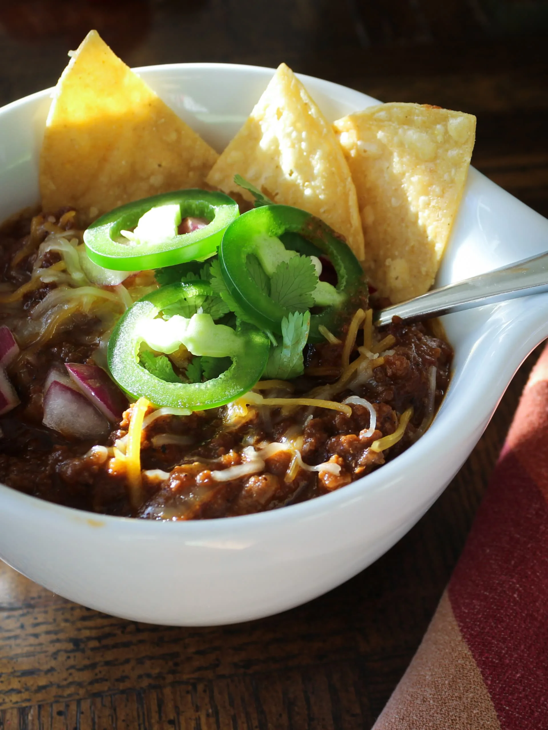 bowl of Texas-style chili with toppings