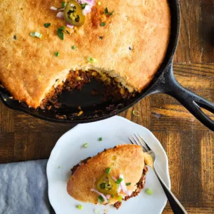 a plate of chili cornbread pie and the skillet - rich, hearty, and delicious