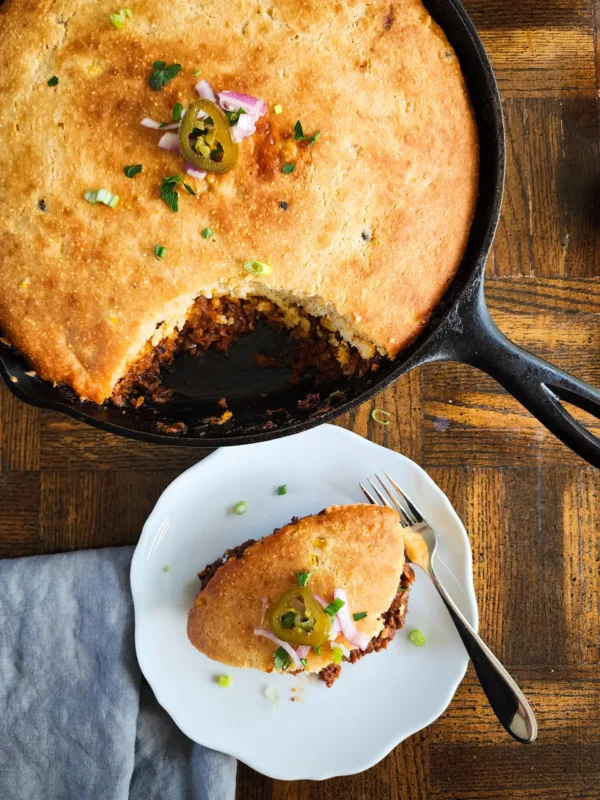 a plate of chili cornbread pie and the skillet - rich, hearty, and delicious