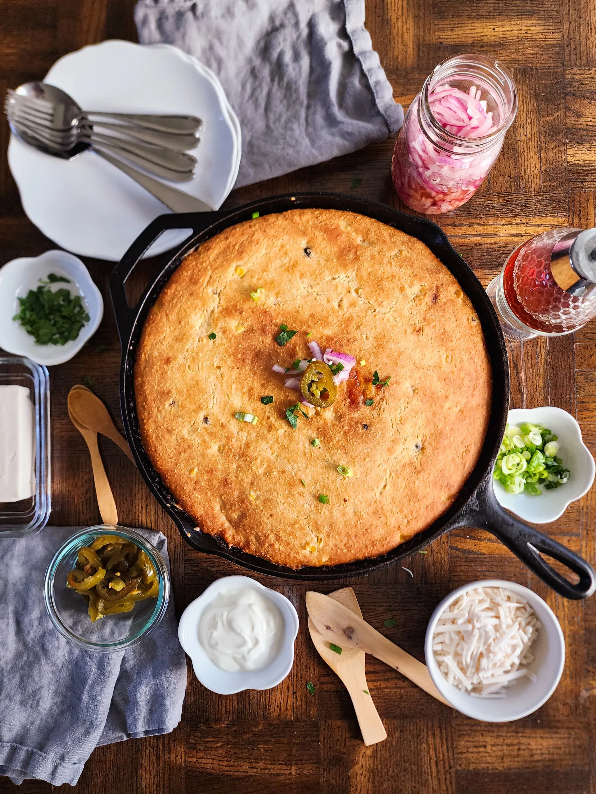 a skillet of chili cornbread pie with all the fixins - rich, hearty, and delicious