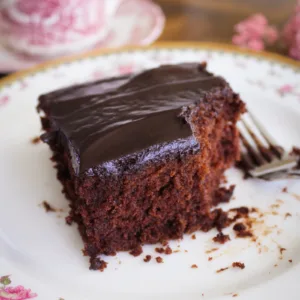 A piece of gluten free chocolate cake on a vintage china plate