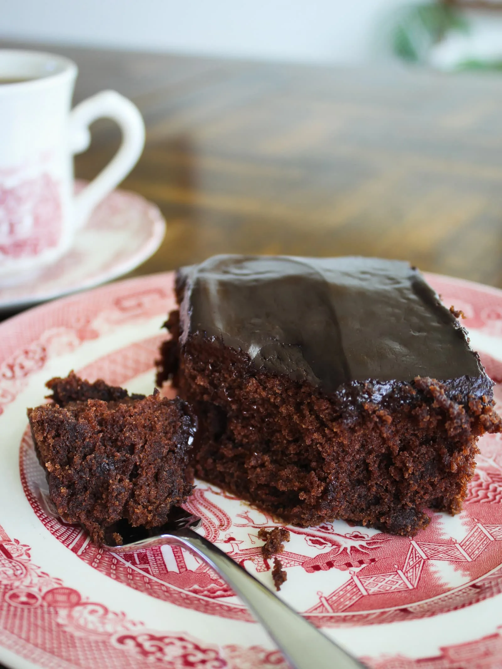 A piece of gluten free chocolate cake on a vintage china plate