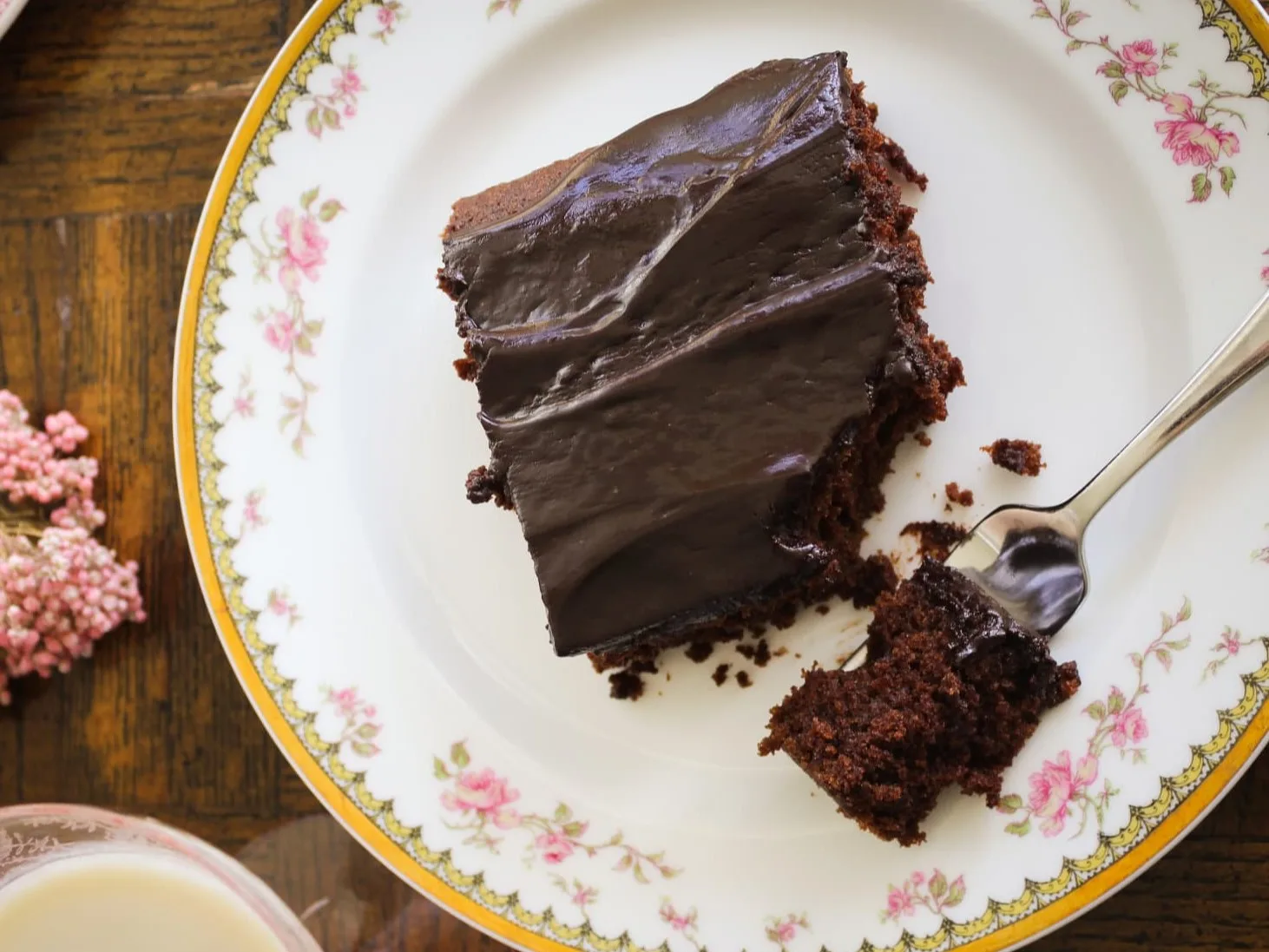 A piece of gluten free chocolate cake on a vintage china plate