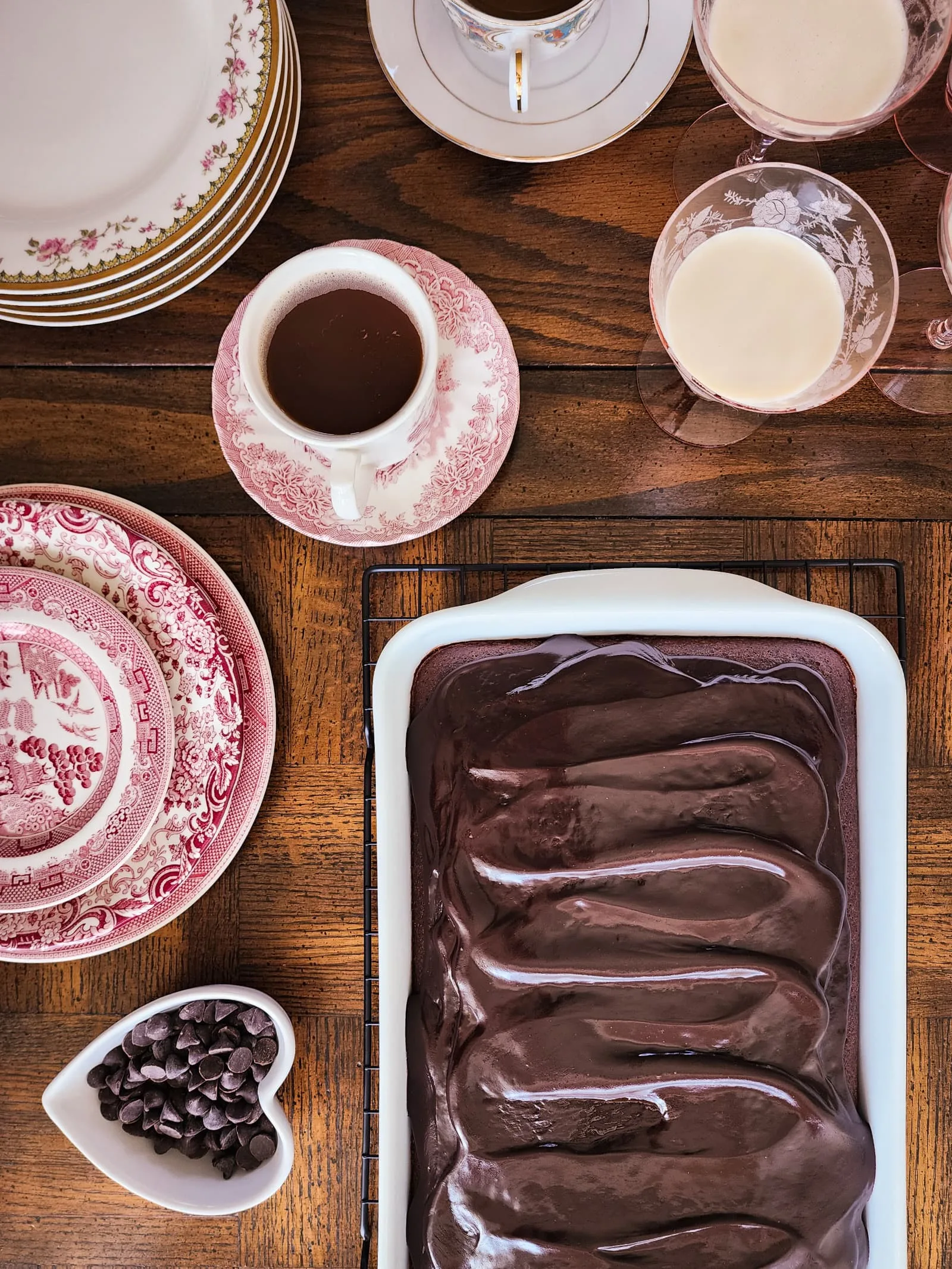 A table laid out with vintage plates and gluten free chocolate cake