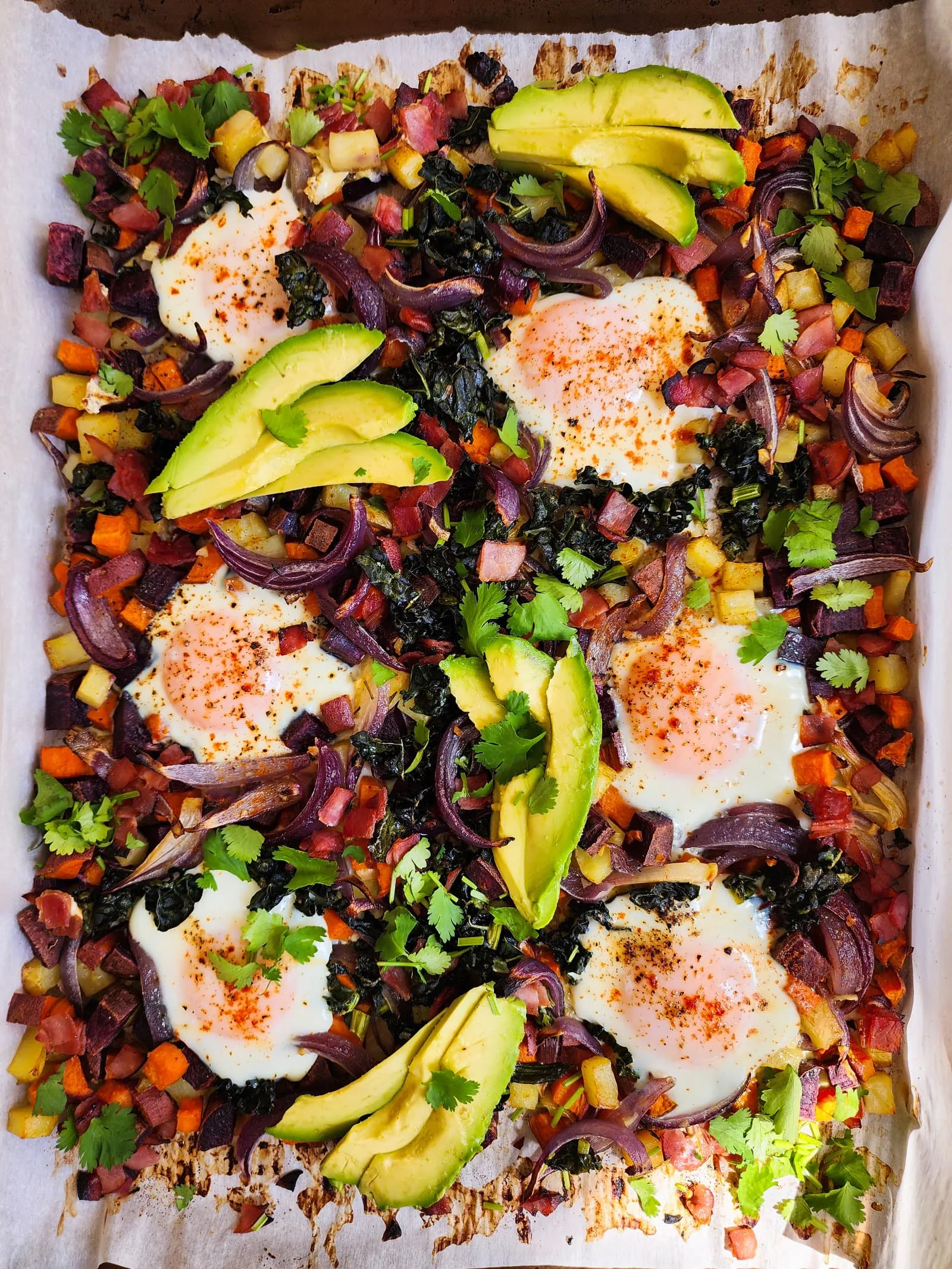 This potato and sweet potato hash recipe features crispy ham, eggs, and fresh greens. Perfect for a slow weekend morning or a home full of guests, or any time you want a hearty breakfast or easy-to-pull-together dinner. Naturally gluten free and dairy free.
