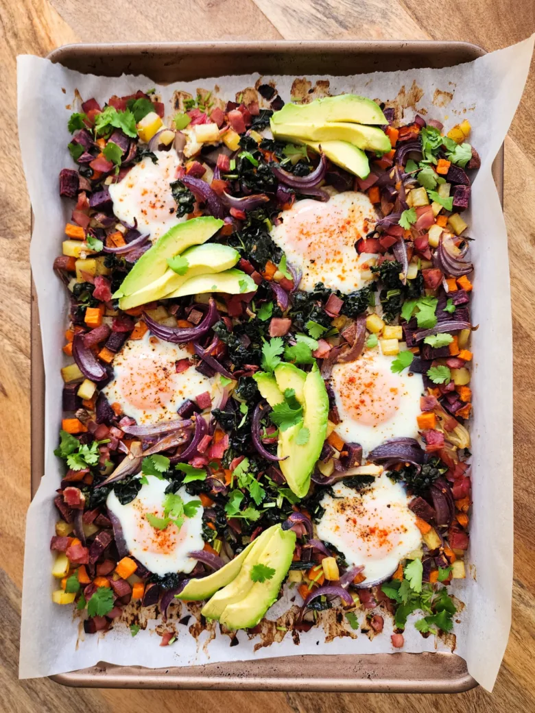 This potato and sweet potato hash recipe features crispy ham, eggs, and fresh greens. Perfect for a slow weekend morning or a home full of guests, or any time you want a hearty breakfast or easy-to-pull-together dinner. Naturally gluten free and dairy free.