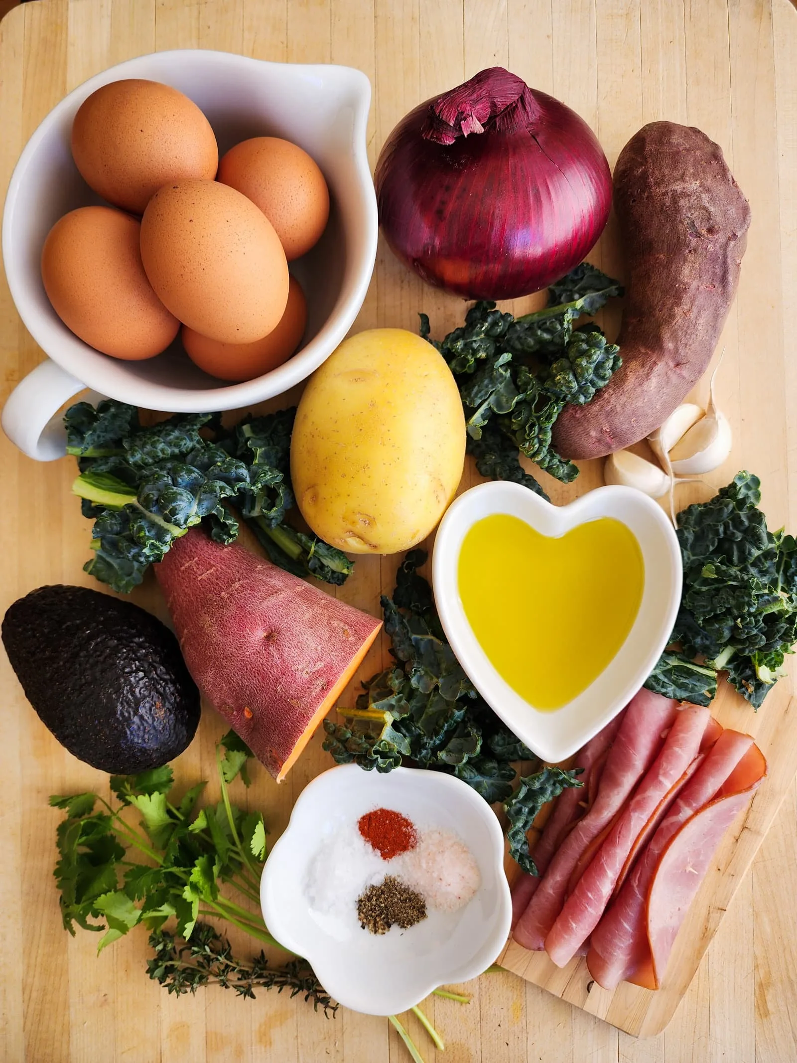 This potato and sweet potato hash recipe features crispy ham, eggs, and fresh greens. Perfect for a slow weekend morning or a home full of guests, or any time you want a hearty breakfast or easy-to-pull-together dinner. Naturally gluten free and dairy free.
