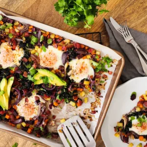 This potato and sweet potato hash recipe features crispy ham, eggs, and fresh greens. Perfect for a slow weekend morning or a home full of guests, or any time you want a hearty breakfast or easy-to-pull-together dinner. Naturally gluten free and dairy free.